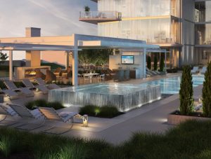 Outdoor view of tower, community pool, lounger chairs, and heated outdoor group entertainment center